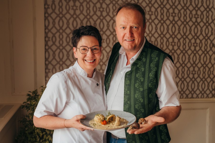 Petra und Werner Zlabinger, © Niederösterreich Werbung/Daniela Führer Ein Mann und eine Frau lächeln und halten einen Teller mit Essen.