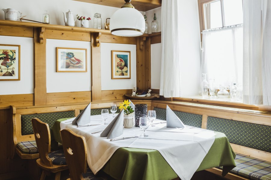 Stube mit Stammtisch, © Niederösterreich Werbung/David Schreiber Gemütliche Stube mit Holzmöbeln, gedecktem Tisch und Bildern an der Wand.