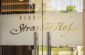 Glastür mit der Aufschrift 'Eisenbock's Strasser Hof'.