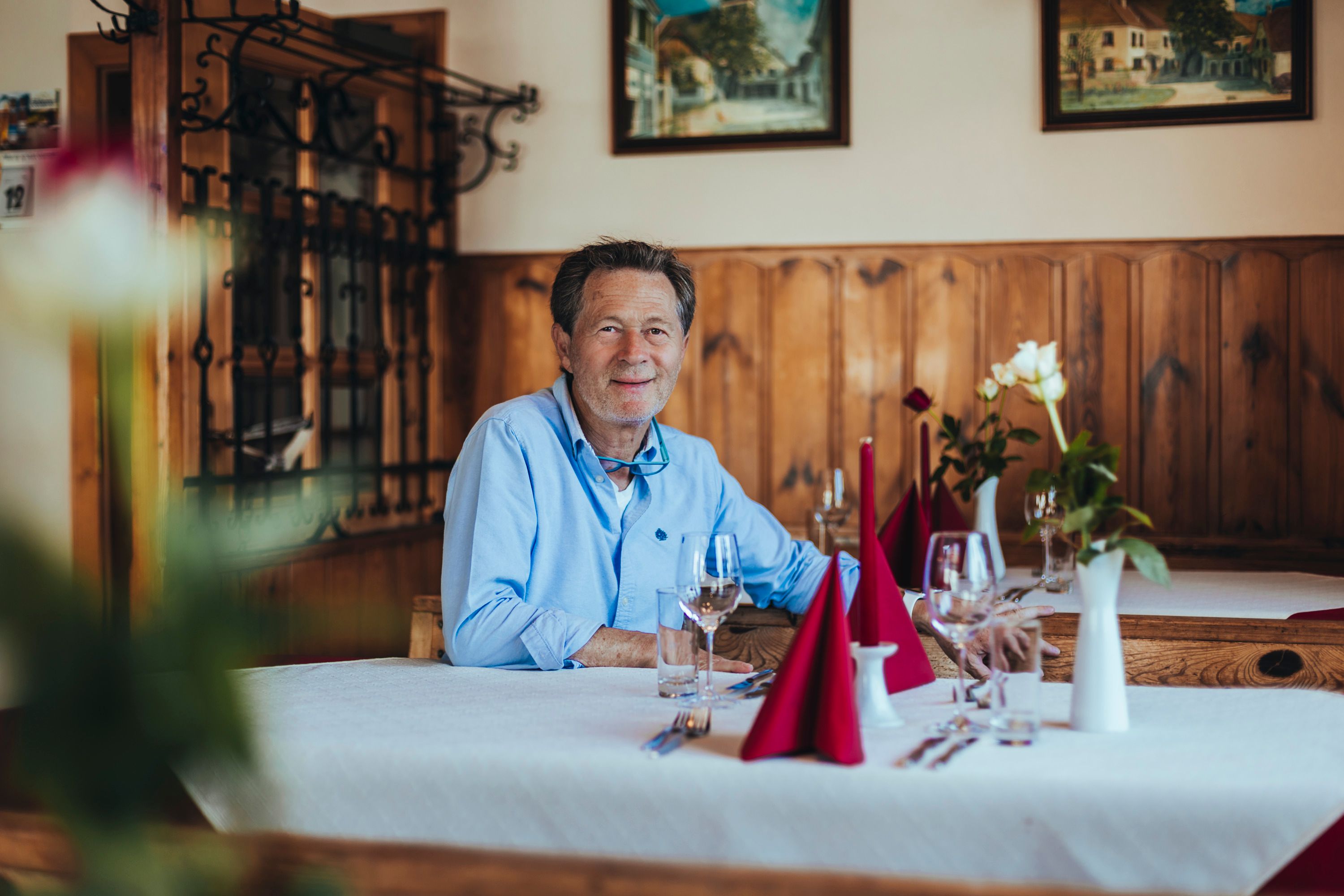 Karlheinz Ringl sits at a laid table in his inn.