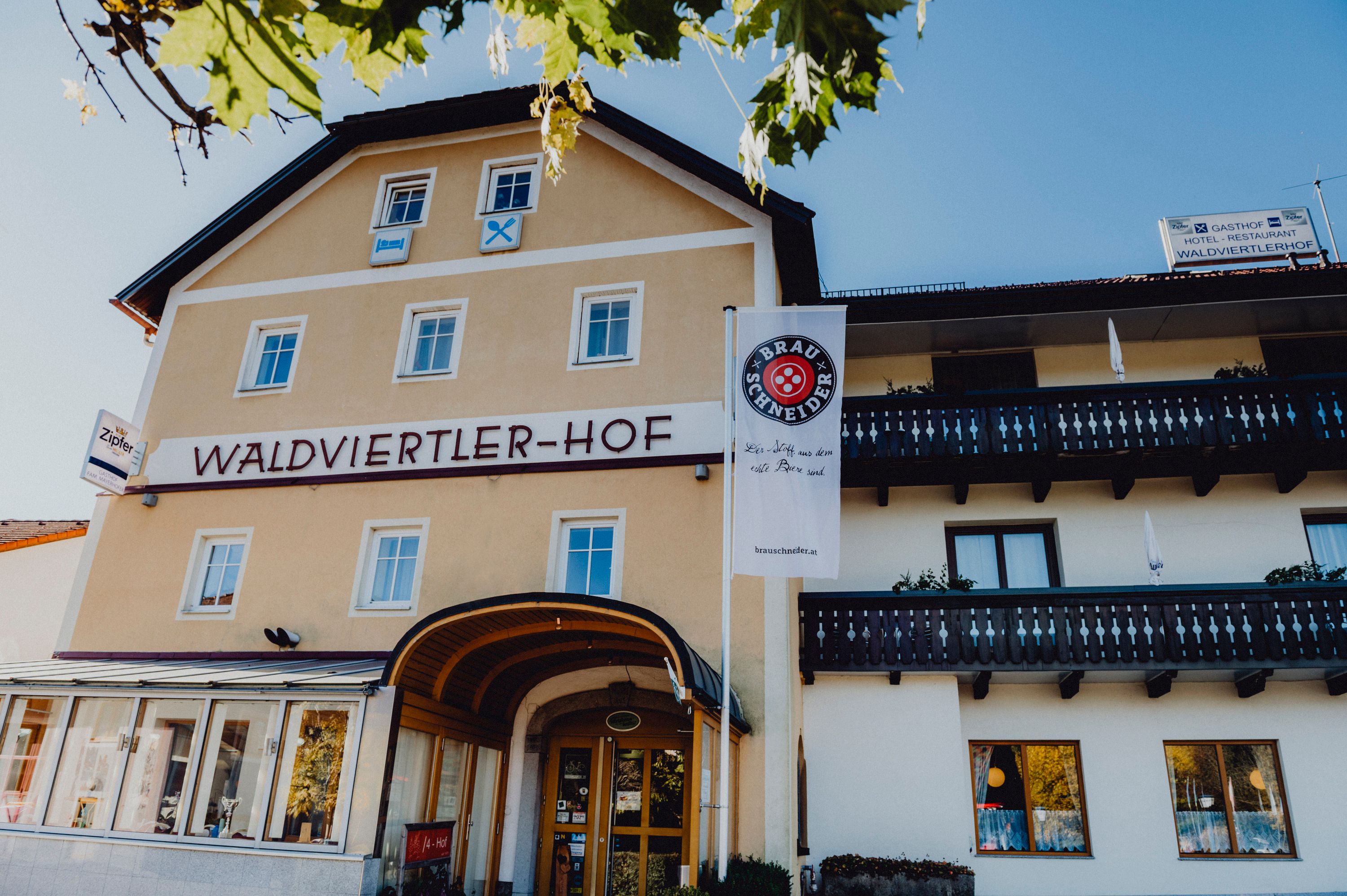 Exterior view of the Waldviertler-Hof with balconies and advertising banner.